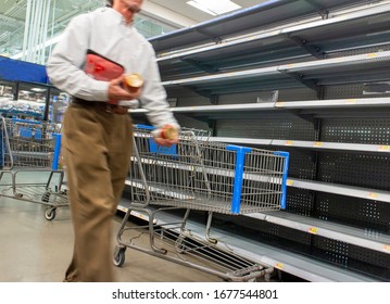 Coronavirus Related Image With Man Blurred Walking Past Empty Shelves At A Supermarket 