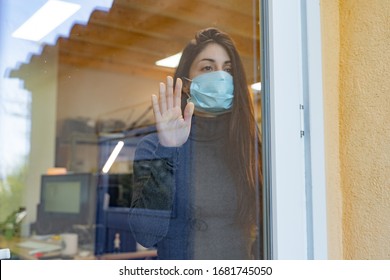 Coronavirus. Sick Woman Of Corona Virus 
Looking Through The Window And Wearing Mask Protection And Recovery From The Illness At Hospital. Quarantine. Patient At Hospital. Prevent Infection.