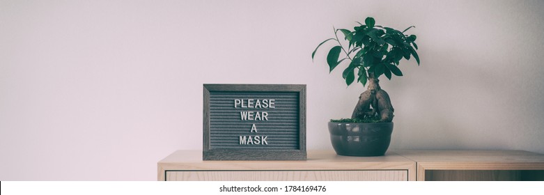 Coronavirus sign with text PLEASE WEAR A MASK upon entering indoor public space retail store panoramic banner. Covid-19 prevention mask obligatory wearing indoors. - Powered by Shutterstock