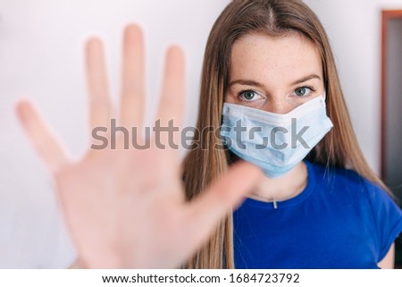 Coronavirus STOP. Girl wearing mask for protect and show stop hand gesture for stop corona virus