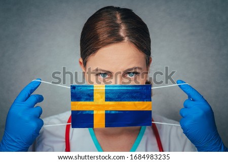 Coronavirus in Sweden Female Doctor Portrait hold protect Face surgical medical mask with Sweden National Flag. Illness, Virus Covid-19 in Sweden, concept photo