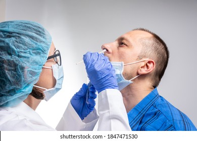 Coronavirus Test - Medical Worker Taking A Swab For Corona Virus Sample From Potentially Infected Man. Covid-19 Nasal Swab Test - Doctor Taking A Mucus Sample From Patient Nose In Hospital