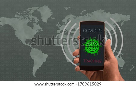 Coronavirus tracking application to reduce coronavirus spreading after quarantine detecting infected people. Phone with app in caucasian male hands against world map