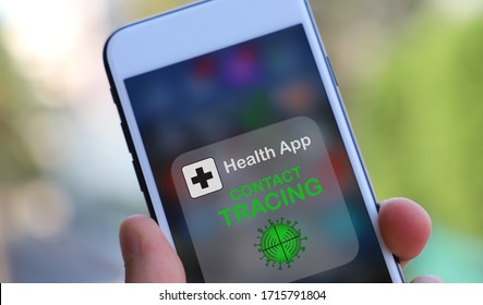 Coronavirus tracking or contact tracing application to reduce coronavirus spreading after quarantine detecting infected people. close up on Phone with app in caucasian hands - Shutterstock ID 1715791804