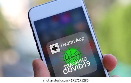 Coronavirus tracking or tracing application to reduce coronavirus spreading after quarantine detecting infected people. close up on Phone with app in caucasian hands - Shutterstock ID 1717175296