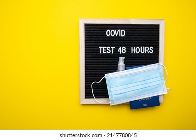 Coronavirus Travel Concept. Passport Medical Mask On A Yellow Background. Text Covid 48 Hours.