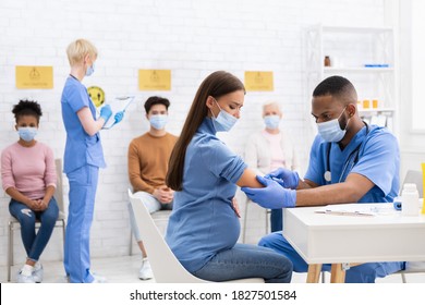 Coronavirus Vaccination. African American Doctor Giving Covid-19 Vaccine Injection To Pregnant Lady Working In Hospital. Corona Virus Population Immunization Campaign Advertisement. Copy Space - Shutterstock ID 1827501584