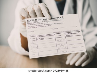 Coronavirus Vaccination Record Card In The Hands Of A Doctor To A Patient Who Has Already Been Vaccinated With Coronavirus. .Coronavirus Prevention