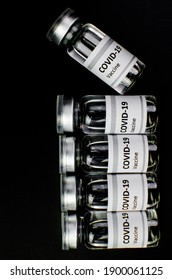 Coronavirus Vaccine Bottle Flipped Isolated On Black Background. Covid-19 Situation Disease Pharmacy In Laboratory And Drug To Cure People.  Healthcare And Medical Concept. Development Of Research.