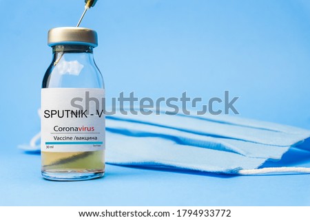 Coronavirus vaccine concept and background. New vaccine sputnik-v isolated on blue background. Covid-19, 2019-nCov pandemic.