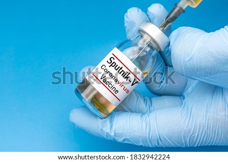 Coronavirus vaccine concept and background. New vaccine sputnik-v isolated on blue background. Covid-19, 2019-nCov pandemic.