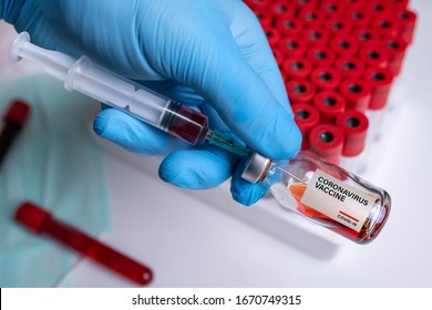 Coronavirus Vaccine  Corona Virus Vaccine Concept With Vial And Syringe On Blue Background