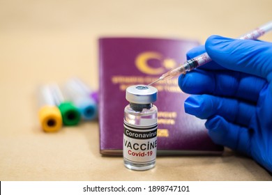 Coronavirus vaccine. Getting vaccinated for international travel. passport and vaccine bottle. doctor wearing gloves makes a vaccine with a syringe in his hand.
Selective Focus