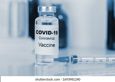 Coronavirus Vaccine - The Medical Concept. Ampoule And Syringe. Copyspace. Blue Toning.