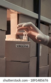 Coronavirus Vaccine Supply Problem And Drug Shortage. Thief With Medical Gloves Steals Medicines From The Warehouse