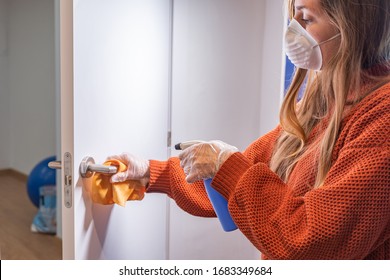 Coronavirus. Woman With Face Mask And Rubber Gloves Cleaning Stuff With A Disinfectant At Home During The Coronavirus Epidemic. Infection Prevention And Control Of Epidemic. Disinfect Your House.