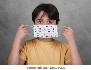 Coronavirus,close-up Of Kid Wearing Homemade Mask Over Gray Background