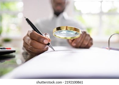 Corporate Auditor Using Magnifying Glass For Tax Fraud Audit