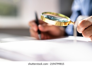 Corporate Auditor Using Magnifying Glass For Tax Fraud Audit