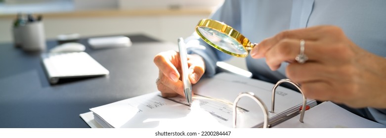 Corporate Auditor Using Magnifying Glass For Tax Fraud Audit