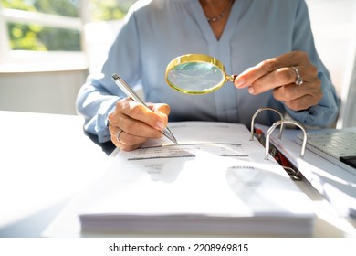 Corporate Auditor Using Magnifying Glass For Tax Fraud Audit