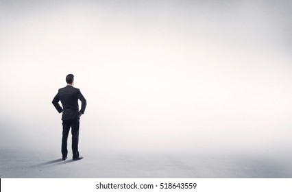 Corporate Business Male In Modern Suit Standing In Big Blank Empty Grey Space Concept