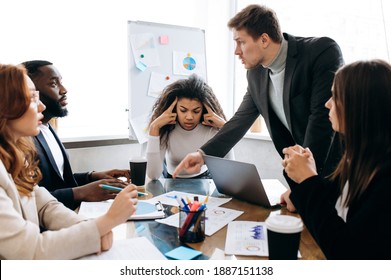 Corporate business negotiations. Frustrated group of multiracial people argue at briefing meeting, cant make an agreement. Upset male and female employee have a work troubles, failed project