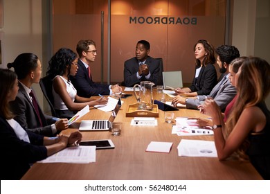 Corporate business people at an evening boardroom meeting