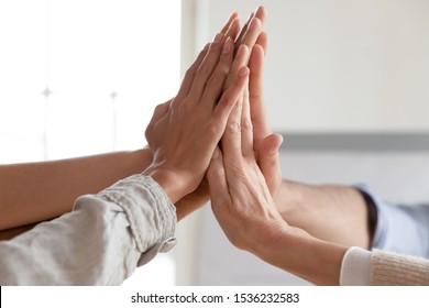 Corporate business team hands joined together close up view, businesspeople group give high five build reliable team concept, power of partnership teamwork, support and unity, professional leadership - Shutterstock ID 1536232583