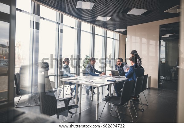 Corporate business\
team and manager in a\
meeting