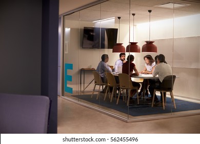Corporate business team at table in a meeting room cubicle