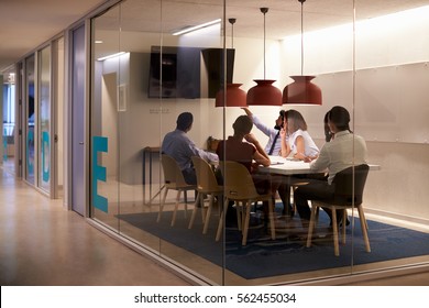 Corporate Business Team Using AV Display In Meeting Cubicle