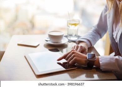 Corporate business woman working on tablet at cafe 