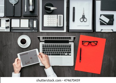 Corporate Businessman Working At Office Desk, He Is Networking With A Digital Tablet, Flat Lay