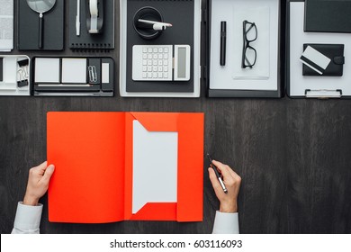 Corporate Businessman Working At Office Desk, He Is Holding A Folder, Business And Finance Concept, Flat Lay