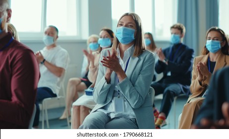 Corporate Diverse Business People Clapping Hands At Successful Conference. Group Of Happy Business People In Face Masks Sitting Together On Meeting Seminar. Quarantine. Workspace.