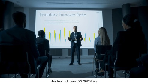 Corporate Event: Caucasian Male Tech CEO Giving Presentation To Colleagues or Investors In the Conference Room Of Innovative Startup Office. Man Talking About Business Objectives and Improving Profits