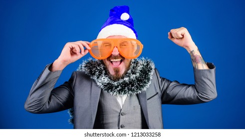 Corporate Holiday Party Ideas Employees Will Love. Corporate Christmas Party. Man Bearded Hipster Wear Santa Hat And Funny Sunglasses. Manager Tinsel Ready Celebrate New Year. Christmas Party Office.