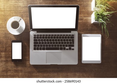 Corporate identity mock up on an hardwood desk with laptop, tablet, smartphone and a cup of coffee