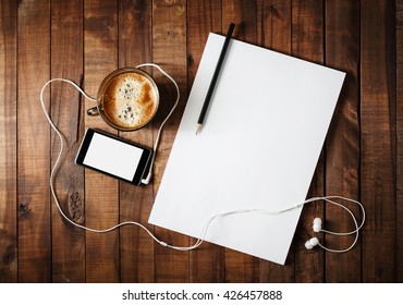 Corporate Identity Template On Vintage Wooden Table Background. Responsive Design Mock-up. Paper, Letterhead, Coffee Cup, Smartphone, Pencil And Headphones. Top View.