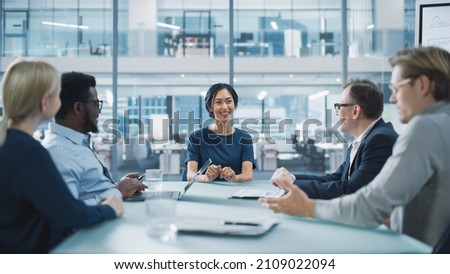 Corporate Meeting Room: Confident Asian Female Executive Director Makes a Report to a Members of the Board and Investors about Company’s Achievement of Record Breaking Annual Revenue Results.