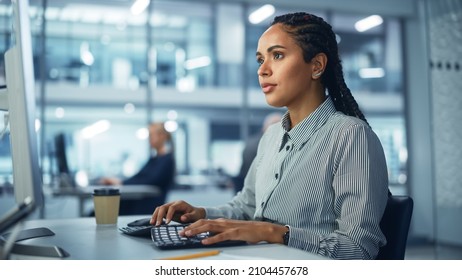 Corporate Office: Black Female IT Technician Using Desktop Computer, Uses Big Data Statistics, Graphs. Smiling Creative Software Engineer Work on eCommerce Project Marketing, Development.