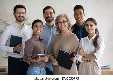 Corporate Portrait Smiling Diverse Employees Team Standing In Office, Looking At Camera, Successful Happy Workers With Middle Aged Leader Posing For Photo, Motivated Staff, Workforce