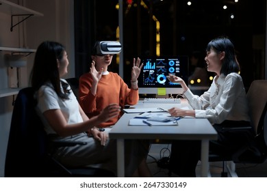 Corporate professionals wearing virtual reality headsets, collaborating on financial analysis during nighttime office hours