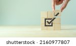 Corporate regulatory and compliance. Goals achievement and business success. Task completion. Ethical corporate. Do the right thing. Quality and ISO symbol. Placing wooden cube with checkmark icon..
