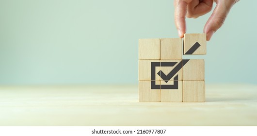 Corporate regulatory and compliance. Goals achievement and business success. Task completion. Ethical corporate. Do the right thing. Quality and ISO symbol. Placing wooden cube with checkmark icon.. - Shutterstock ID 2160977807