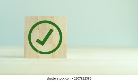 Corporate regulatory and compliance. Goals achievement and business success. Task completion. Ethical corporate. Do the right thing. Quality and ISO symbol. Wooden cube with green checkmark icon. - Shutterstock ID 2207922393