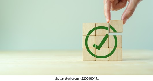 Corporate regulatory and compliance. Goals achievement and business success. Task completion. Ethical corporate. Do the right thing. Quality and ISO symbol. Wooden cube with green checkmark icon. - Shutterstock ID 2208680451