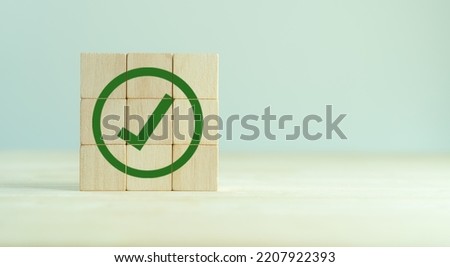 Corporate regulatory and compliance. Goals achievement and business success. Task completion. Ethical corporate. Do the right thing. Quality and ISO symbol. Wooden cube with green checkmark icon.