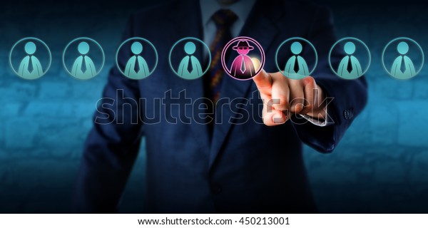 Corporate security manager identifies a\
potential insider threat in a line-up of eight white collar\
workers. Hacker or spy icon lights up purple. Cybersecurity and\
human resources challenge\
concept.